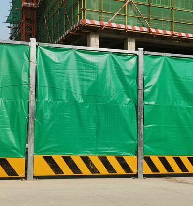 Green PVC fabric used as a construction site barrier