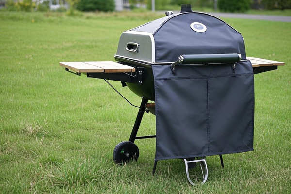 Oxford fabric grill cover protecting a barbecue grill from rain and dust