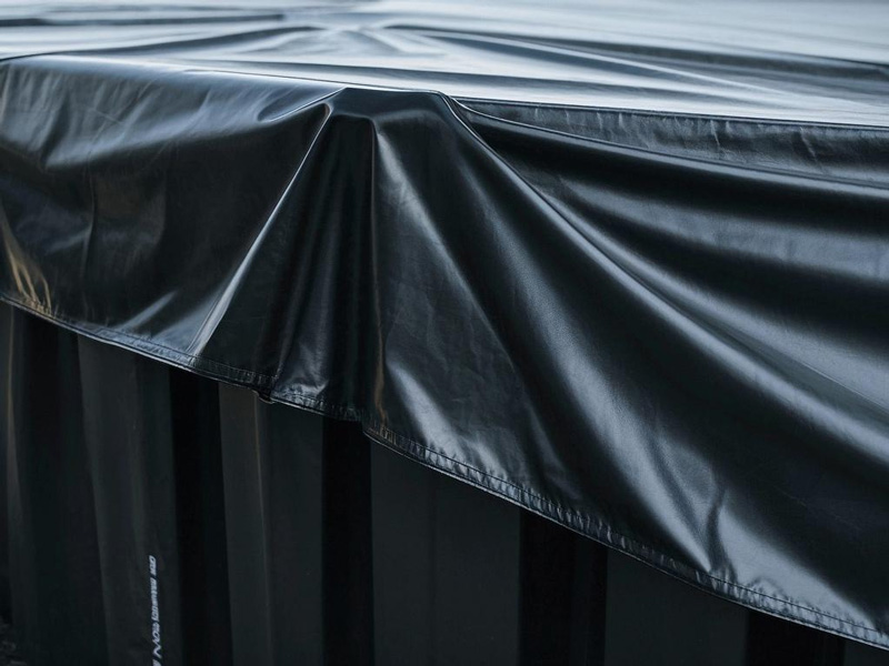 Container tarp being secured