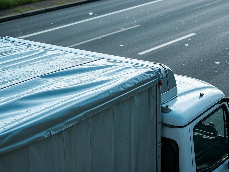 Truck with roof deflector tarp installed showing aerodynamic design