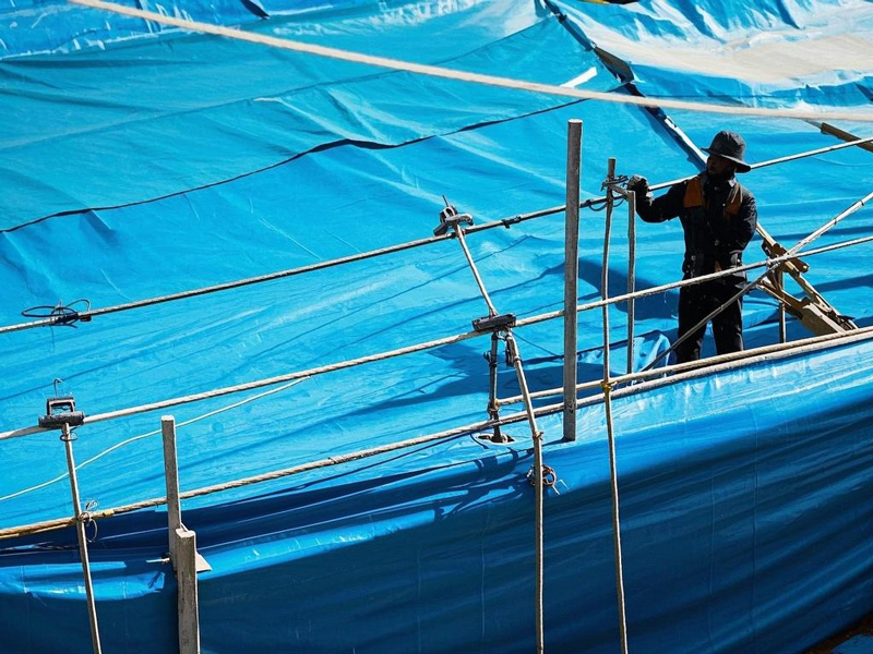 Heavy duty PVC tarp covering construction materials on building site