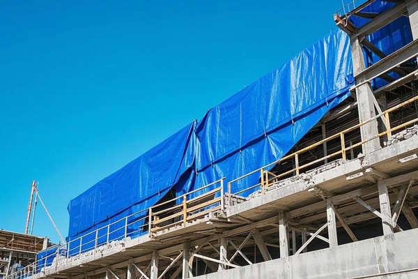 Tarp covering building materials on construction site