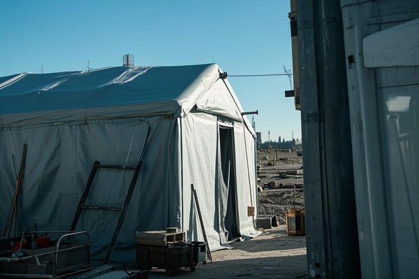 Temporary construction shelter with roof tarp