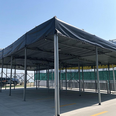 Large temporary structure with white roof tarp