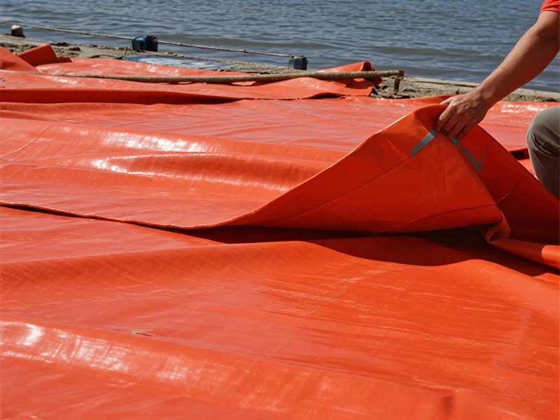 Heavy-duty PVC flood control tarp deployed as emergency barrier