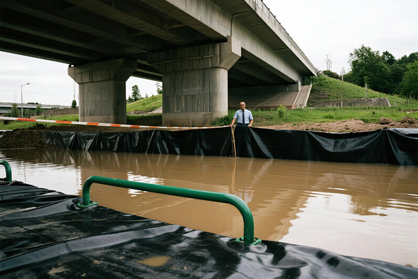 Industrial facility protected by flood control tarps