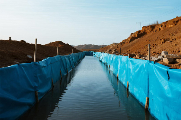 Temporary channel created by flood tarps for water diversion