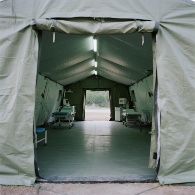 Medical team using tarp as field hospital