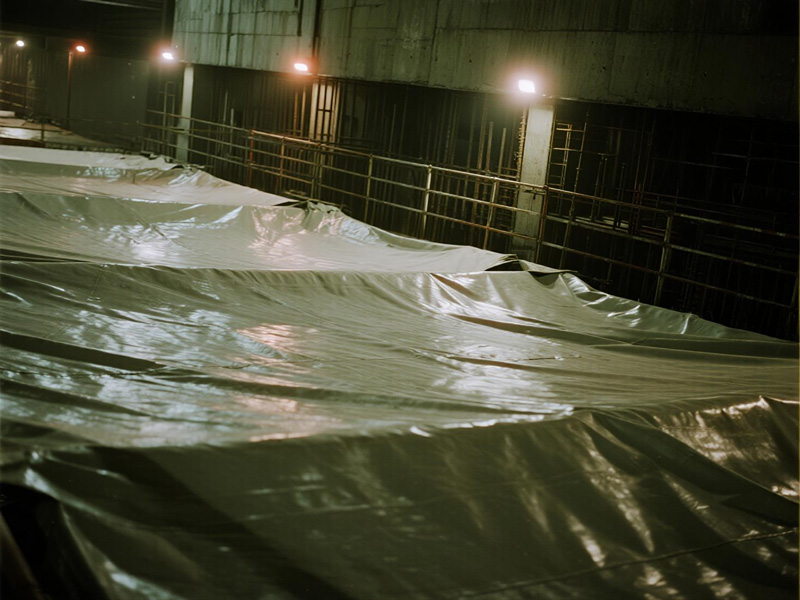 Workers installing heavy-duty tunnel tarp