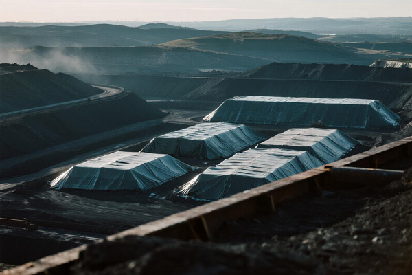 Mine site tarp covering material stockpiles