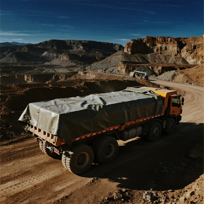 Mining truck covered with protective tarp
