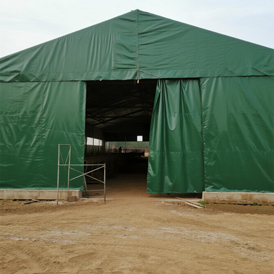 Side view of tarp-covered animal shelter with ventilation panels