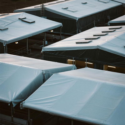 Detail of tarp attachment system for livestock shelters