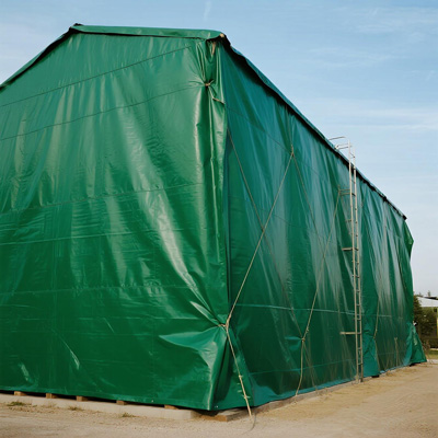 Interior view of warehouse with covered grain storage containers