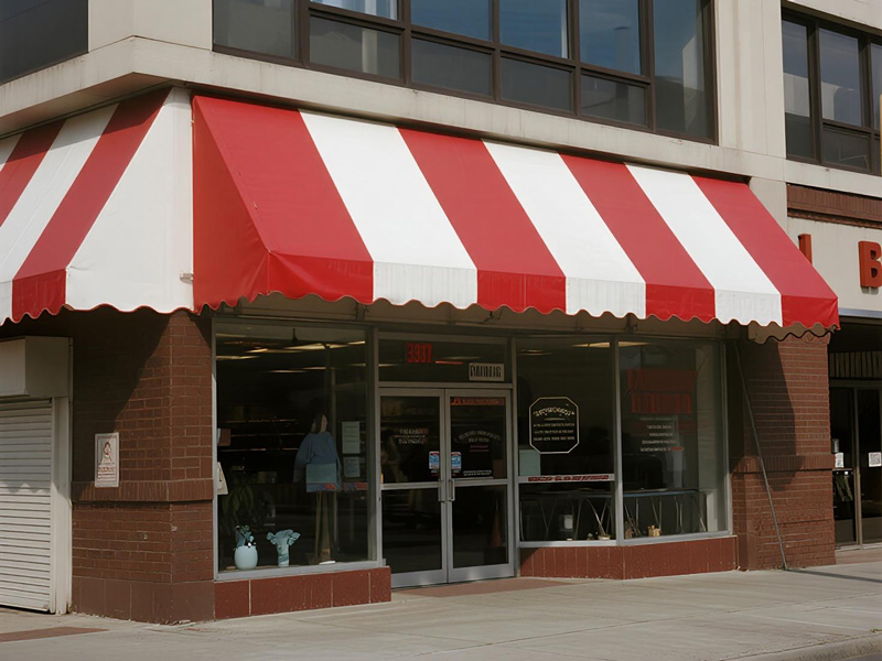 Brand-printed commercial awning displaying shop logo