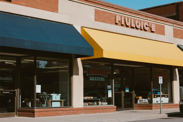 Retail storefront with branded fixed awning attracting customers