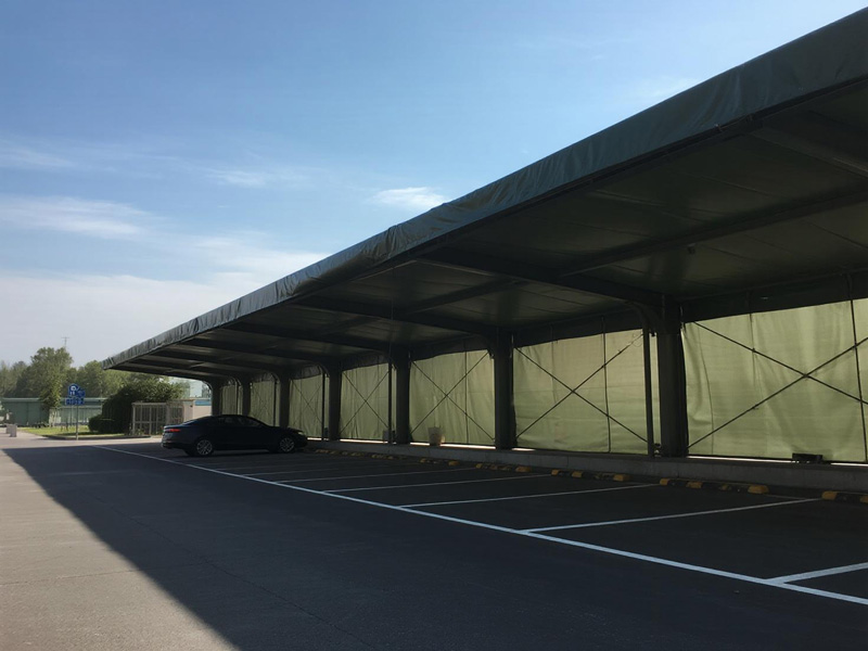 Car parked under shade cloth structure showing temperature reduction effect