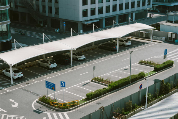 Office building parking with shade cloth covering employee and visitor parking
