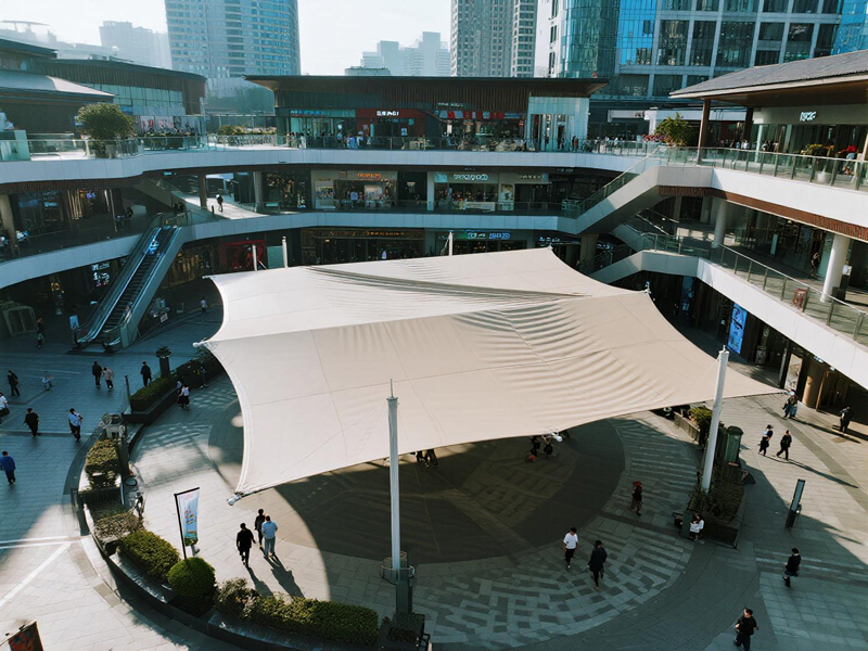 Aerial view of large shade canopy covering commercial plaza gathering space