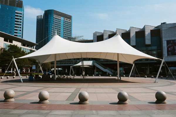 Downtown public square with large shade canopy covering events and gathering space