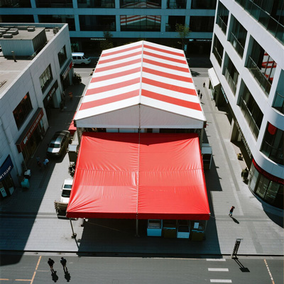 Expansive shade structure covering commercial plaza with seating and landscaping