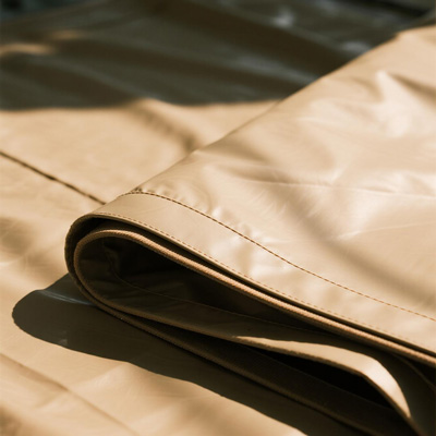 Large shade canopy covering outdoor event space in commercial plaza