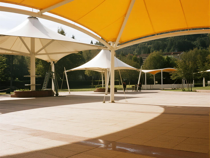 Scenic area with custom designed shade cloth structures blending with natural surroundings, providing sun protection for visitors