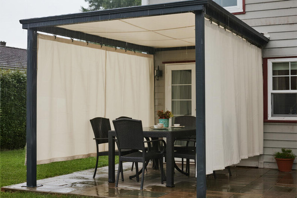 Residential patio with rain curtains protecting outdoor dining set