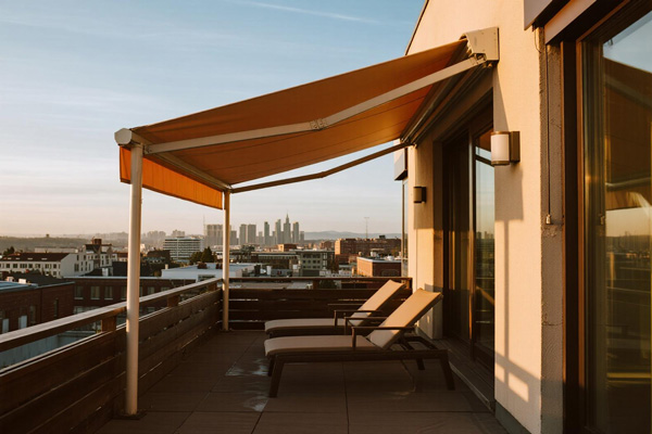 Home terrace with lounge furniture protected by rain curtains