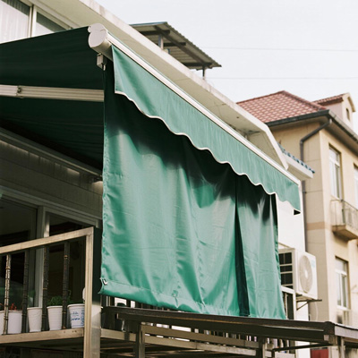 Evening view of patio with rain curtains lit from inside