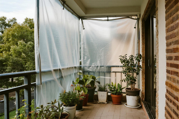 Condo balcony with plants protected by rain cover