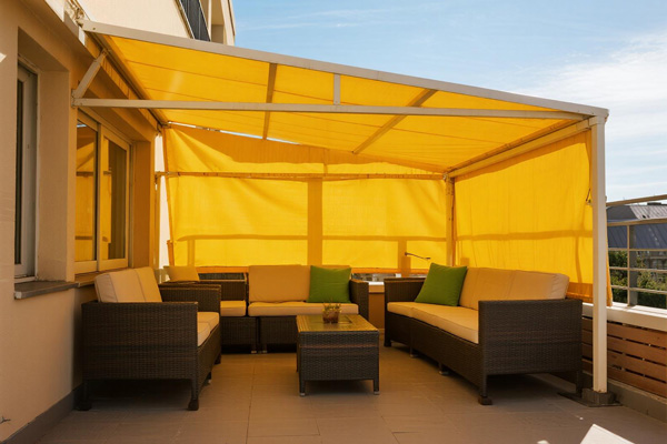 Small balcony used as outdoor seating area with cover