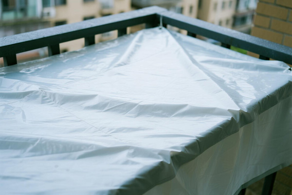 Balcony cover protecting outdoor furniture during rainy season