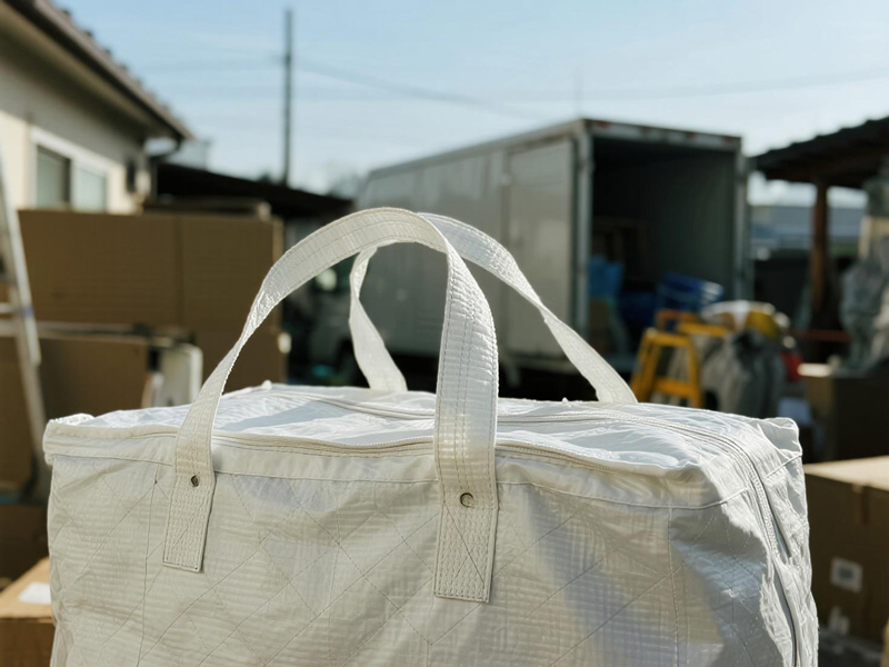 Multiple furniture items protected by dust covers during storage