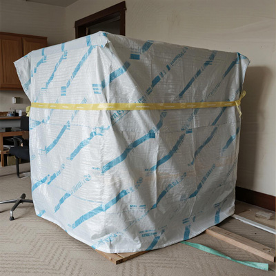 Close-up of paint splatters on cover protecting sofa
