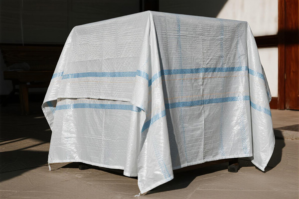 Furniture covered with dust sheets in a storage room