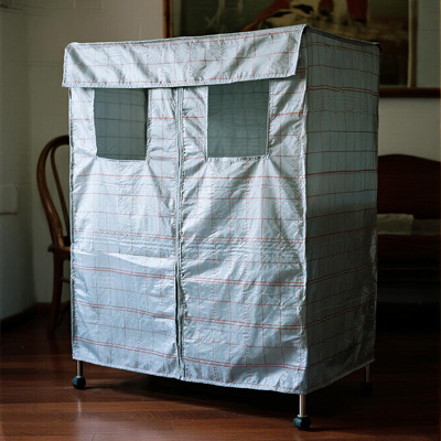 Closet with seasonal clothing covered in dust protectors