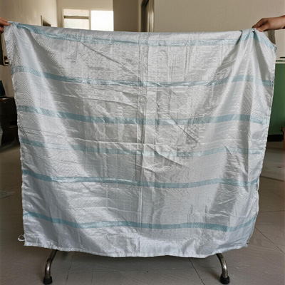 Dining chairs covered with dust sheets in storage