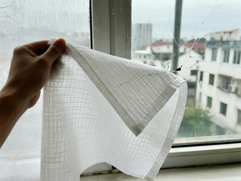 Broken window covered with emergency rain and sun protection sheet