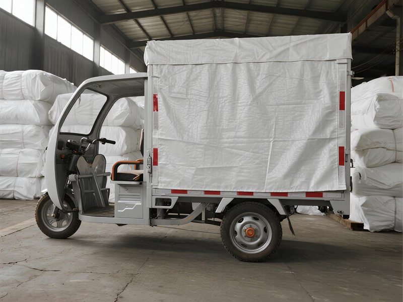 Small truck with cargo covered by PE tarpaulin