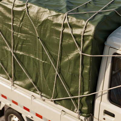 Close-up of reinforced grommet on truck tarpaulin