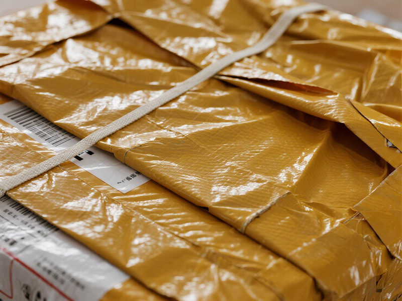 Delivery packages protected by waterproof rain covers during rain