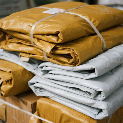 Various sizes of parcel rain covers protecting packages in rain