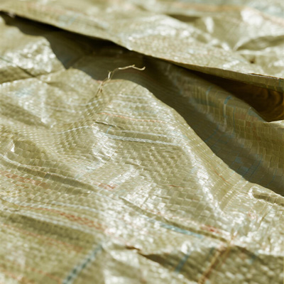 Courier applying adhesive rain cover to a package