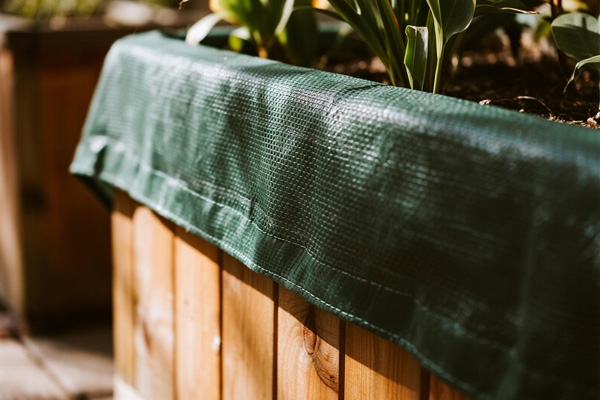 Rain cover on wooden garden planter boxes
