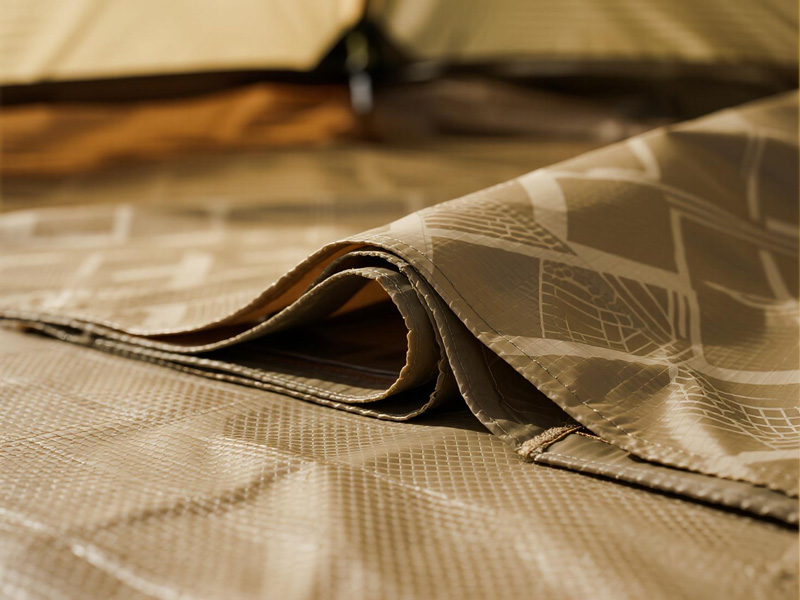 Compact folded tent footprint in carry bag