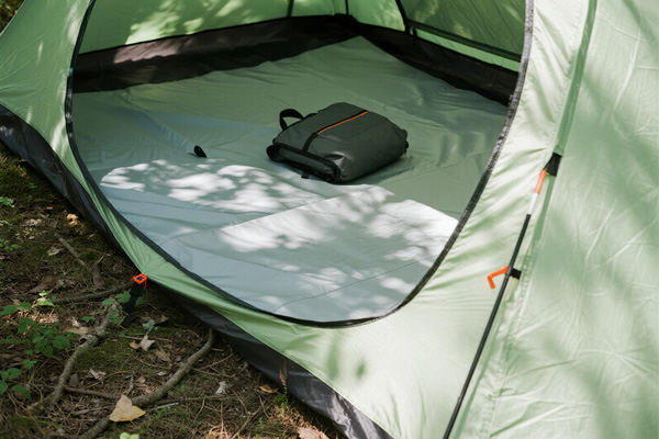 Tent footprint used in forest camping setting