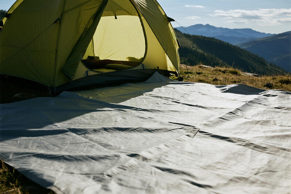 Mountain camping with tent footprint on rocky terrain