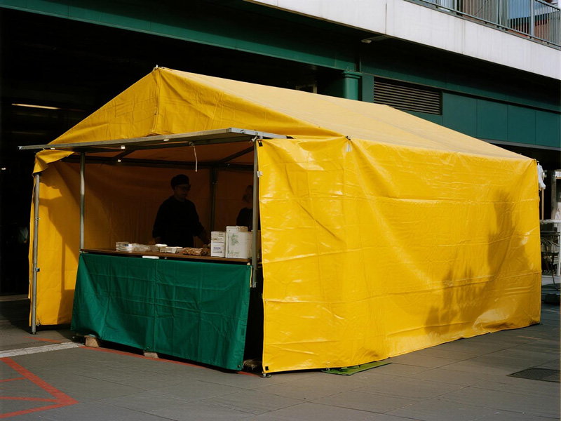 Close-up of market stall tarp material showing reinforced weave