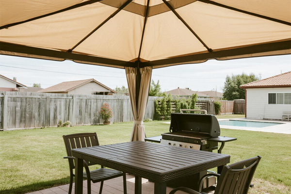 Residential backyard BBQ with rain cover